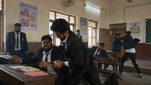 A fight breaking out between uniformed students in an old classroom, with more scuffles continuing in the background.