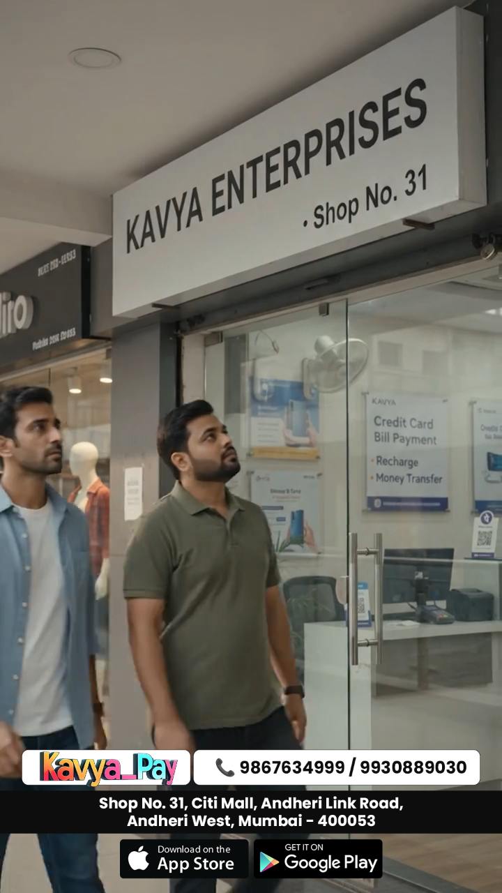 The Kavya Enterprises shopfront in a Mumbai mall, two men walking in past the payments signage.